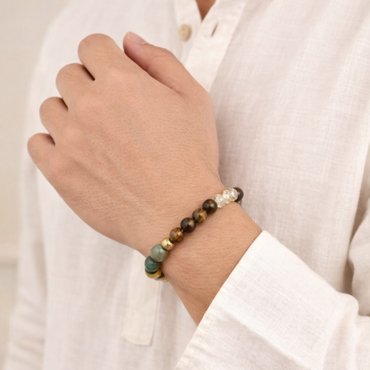 Close-up of a hand wearing a dhan yog bracelet